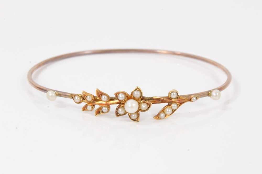 Lot 116 - Victorian yellow metal seed pearl bangle with floral decoration, boxed