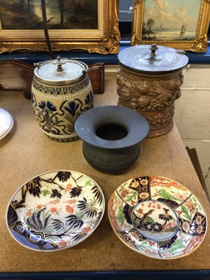 Lot 227 - Doulton Lambeth biscuit barrel, together with a further salt-glazed biscuit barrel, a Wedgwood basalt bowl, and two 19th century saucers (5)