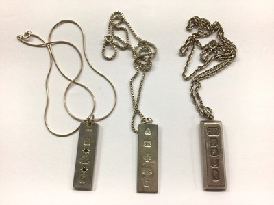 Lot 693 - Three silver ingots, all on silver chains