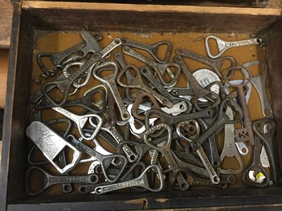 Lot 359 - Collection of vintage bottle openers in wooden cabinet