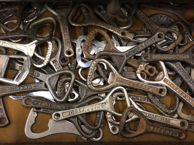 Lot 359 - Collection of vintage bottle openers in wooden cabinet