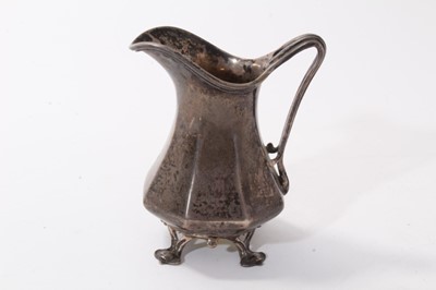 Lot 385 - 1920 silver cream jug of hexagonal baluster form, with reeded handle, on four pad feet