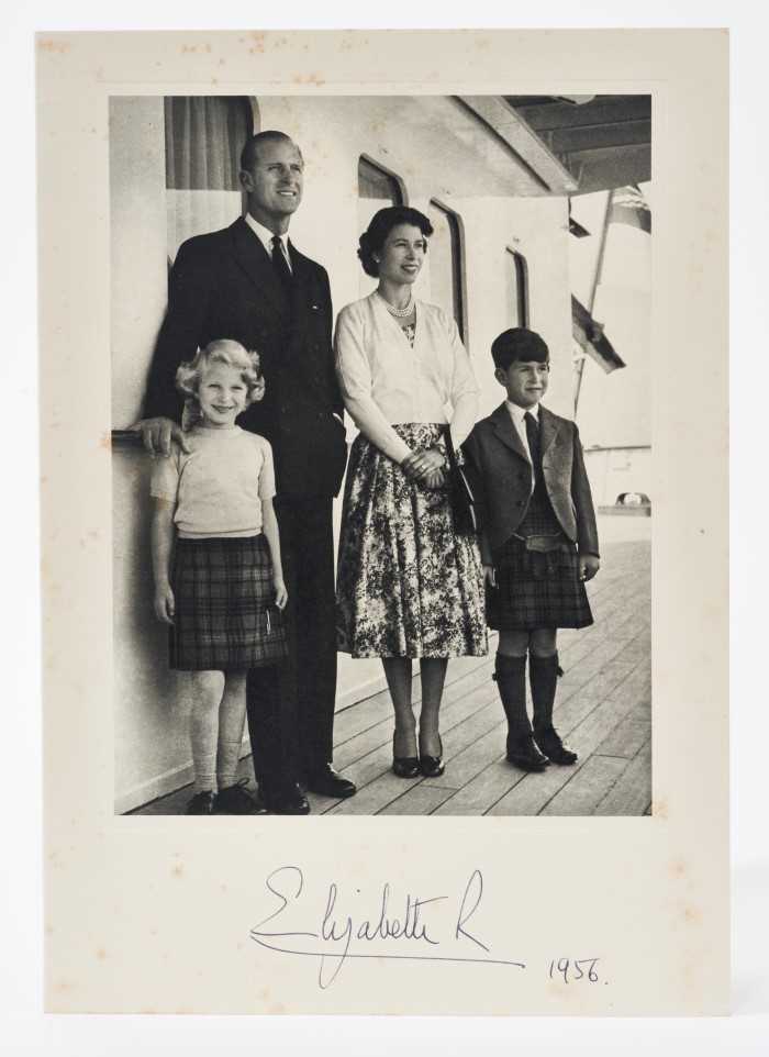 Lot 69 - H.M.Queen Elizabeth II, signed 1956 Christmas card with gilt crown to cover, charming photograph of the Royal couple and children on board the Royal Yacht, signed' Elizabeth R 1956' with envelope