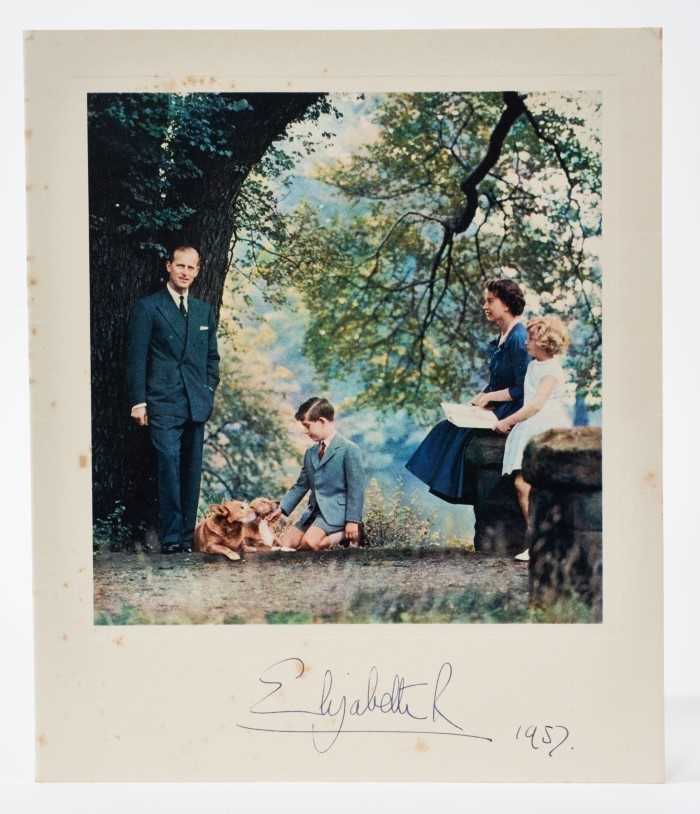 Lot 70 - H.M.Queen Elizabeth II signed 1957 Christmas card with gilt crown to cover, charming colour photograph of the Royal couple with their two children and corgis at the base of a tree , signed ' Elizab...