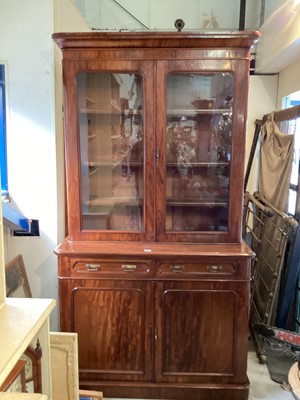 Lot 1011 - Victorian mahogany two height bookcase with adjustable shelves above enclosed by two glazed doors, two drawers and two panelled doors below, 123.5cm wide, 48cm deep, 222cm high