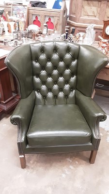 Lot 1026 - Leather upholstered wing armchair