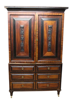 Lot 1309 - Early 19th century Dutch colonial hardwood and ebonised linen press, with ripple moulded cornice and enclosed by pair of fielded panel doors with swag appliqués, the base having two short over two...