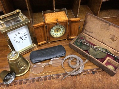 Lot 495 - Brass cased carriage clock, one other timepiece in wooden case, set scales, pair antique spectacles, trench art lighter and artefacts