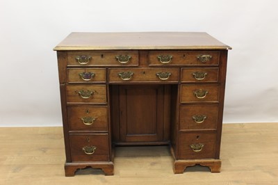 Lot 1324 - George III mahogany kneehole estate desk, with eleven drawers about the cupboard kneehole on bracket feet, 92cm wide x 53cm deep x 79cm high