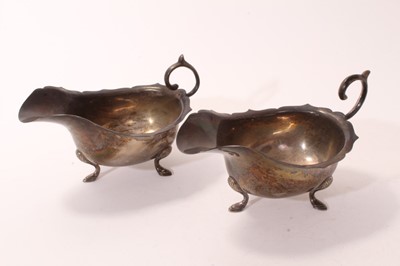 Lot 407 - Pair 1930s silver sauce boats of conventional form, with open scroll handles