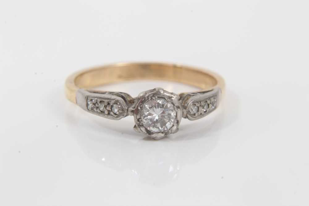 Lot 147 - Diamond single stone ring with diamond set shoulders on yellow metal shank