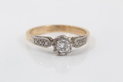 Lot 147 - Diamond single stone ring with diamond set shoulders on yellow metal shank