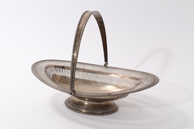 Lot 412 - George V silver swing handled cake basket, with pierced decoration and bead border