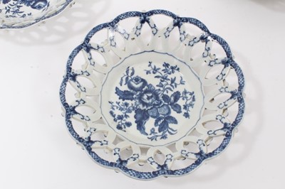 Lot 107 - Three Worcester blue and white Pinecone pattern pierced baskets, circa 1770, the outsides with moulded flowers, two with crescent marks, 21.5cm diameter