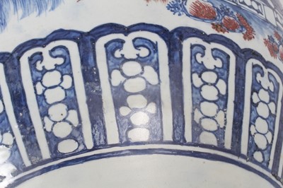 Lot 261 - Large Chinese porcelain fish bowl, 20th century, decorated in underglaze blue and red with landscape scenes and patterned borders