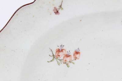 Lot 109 - A Chelsea scalloped oval dish, circa 1755, polychrome painted with floral sprays, brown-painted rim, red anchor mark to base, 32.5cm wide