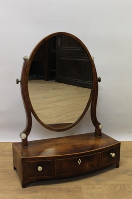 Lot 1373 - Regency mahogany bowfront swing frame toilet mirror