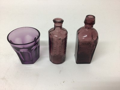 Lot 581 - Amethyst tinted glass medicine bottle, another, and a small amethyst glass beaker