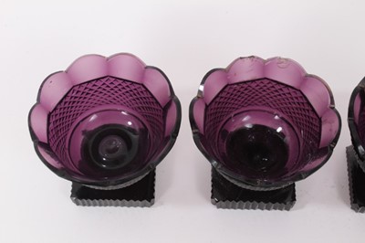 Lot 271 - A set of four 19th century amethyst tinted glass salts