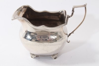 Lot 444 - George III Irish silver milk jug with floral engraved decoration on scroll feet (Dublin 1813) 5ozs