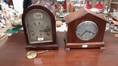 Lot 595 - Twentieth century mahogany mantel clock with silvered dial, 34.5cm high, together with another mantel clock (2)