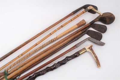 Lot 897 - Callow & Son bamboo riding crop, silver gilt mounted cane with horn handle, one other twisted cane and five antique golf clubs (8)