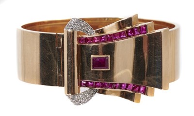 Lot 604 - 1940s Art Deco Odeonesque rose gold diamond and synthetic ruby clip, the undulating rose gold scroll with calibre cut rubies (possibly synthetic) and pavé set single cut diamonds. Signed with maker...