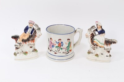 Lot 247 - Pair of Victorian Staffordshire figures of children on goats, together with a pottery frog mug (3)