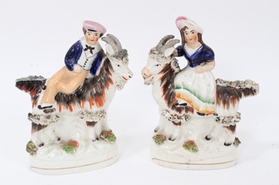 Lot 247 - Pair of Victorian Staffordshire figures of children on goats, together with a pottery frog mug (3)