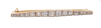 Lot 648 - Art Deco diamond bar brooch with 17 old cut diamonds in box shaped platinum millegrain setting on gold mount with engraved gallery. Converted from a bracelet. Estimated total diamond weight approxi...