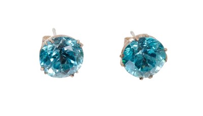 Lot 651 - Pair of blue zircon single stone stud earrings, each with a round mixed cut blue zircon measuring approximately 8.9mm - 9.1mm in claw setting with post and butterfly fittings.