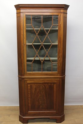 Lot 1412 - Late 19th century mahogany two height corner cupboard, the astragal glazed door enclosing three shaped shelves, with panelled cupboard below, on bracket feet