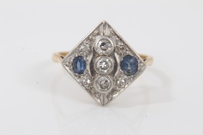 Lot 708 - Art Deco style diamond and sapphire cocktail ring with a square plaque set with two oval mixed cut blue sapphires and seven single cut diamonds, in platinum setting on 18ct yellow gold shank. Ring...