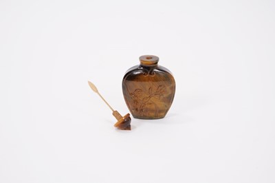 Lot 918 - Fine carved tiger-eye snuff bottle, relief carved with flowering shrubs, with conforming stopper, 6cm high