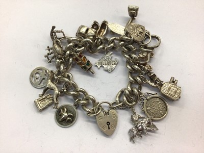 Lot 954 - Silver charm bracelet with padlock clasp and various silver/white metal novelty charms