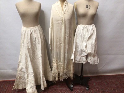 Lot 2153 - A selection of Victorian /Edwardian clothing including a stiffened cream Moire skirt with tiered ruffles, cotton bonnet with lace and ruffles, a pair of split leg bloomers with pink robbons and lac...