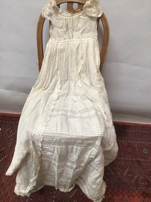 Lot 2154 - A selection of Victorian/ Edwardian babies clothing including four caps, three lace and embroidery Christening gowns, two Christening petticoats, also a girl's cut-out work dress and a plain pettic...