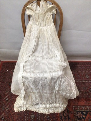 Lot 2154 - A selection of Victorian/ Edwardian babies clothing including four caps, three lace and embroidery Christening gowns, two Christening petticoats, also a girl's cut-out work dress and a plain pettic...
