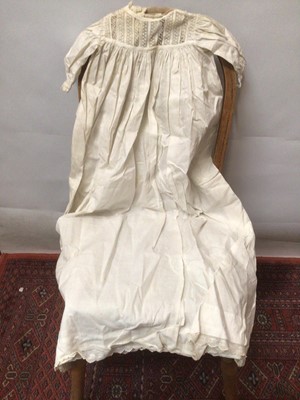 Lot 2154 - A selection of Victorian/ Edwardian babies clothing including four caps, three lace and embroidery Christening gowns, two Christening petticoats, also a girl's cut-out work dress and a plain pettic...