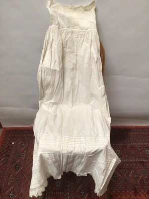 Lot 2154 - A selection of Victorian/ Edwardian babies clothing including four caps, three lace and embroidery Christening gowns, two Christening petticoats, also a girl's cut-out work dress and a plain pettic...