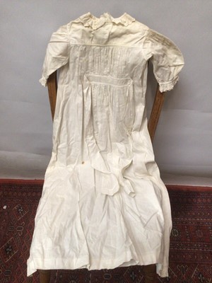 Lot 2154 - A selection of Victorian/ Edwardian babies clothing including four caps, three lace and embroidery Christening gowns, two Christening petticoats, also a girl's cut-out work dress and a plain pettic...