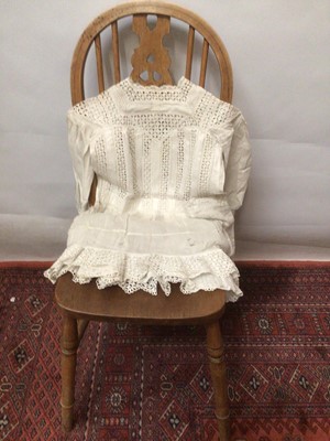Lot 2154 - A selection of Victorian/ Edwardian babies clothing including four caps, three lace and embroidery Christening gowns, two Christening petticoats, also a girl's cut-out work dress and a plain pettic...