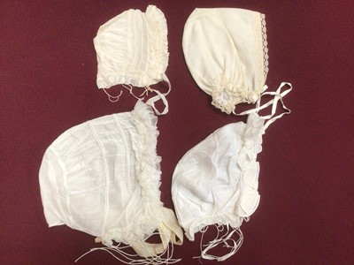Lot 2154 - A selection of Victorian/ Edwardian babies clothing including four caps, three lace and embroidery Christening gowns, two Christening petticoats, also a girl's cut-out work dress and a plain pettic...