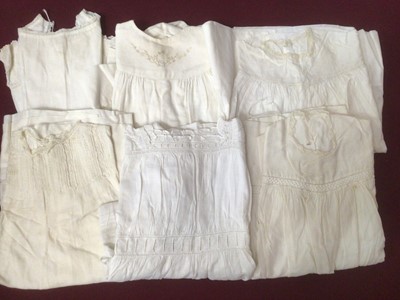 Lot 2155 - Early to Mid 20th century babies clothing including embroidered cream woven wool jacket, dress and petticoat, cotton and lace dresses and petticoats, plus some hand knitted items