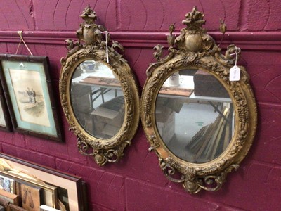 Lot 337 - Pair of Victorian gilt gesso oval mirrors, with oval vacant cartouche crests and scroll and foliate decorated aprons