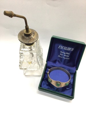 Lot 728 - Silver Excalibur bangle set with three green stones, together with a silver topped glass perfume bottle