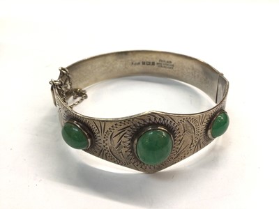 Lot 728 - Silver Excalibur bangle set with three green stones, together with a silver topped glass perfume bottle