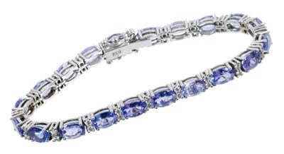 Lot 446 - Tanzanite and diamond line bracelet in 18ct white gold setting