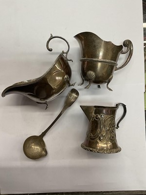 Lot 760 - Two Edwardian silver cream jugs and an Irish silver cream ladle and a silver sauce boat