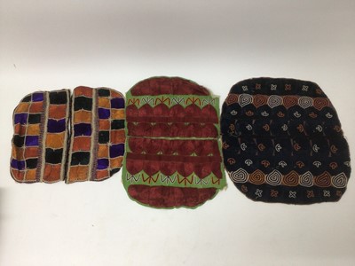 Lot 2184 - A selection of antique Pakistani embroidery items, vibrant silk floss darning stitches and chain stitches on hand woven cotton. Including women's top and top front, tea cosy, pairs of panels...